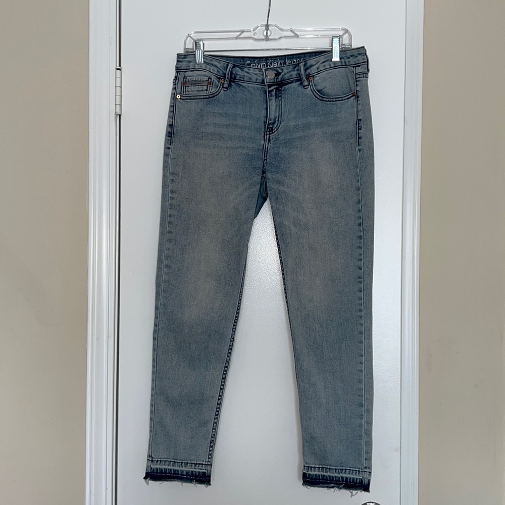 Calvin Klein dirty, light washed skinny ankle jeans.